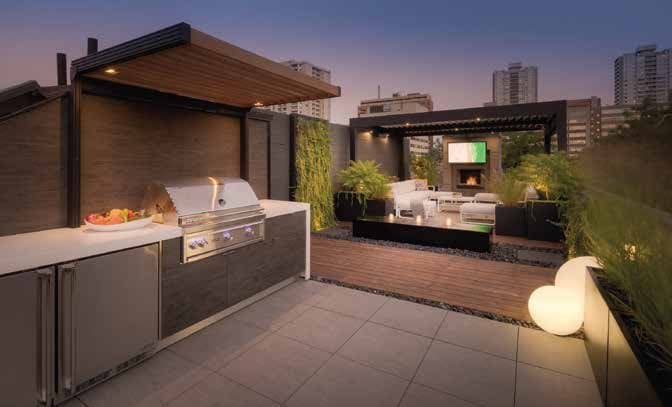 Rooftop outdoor kitchen and lounge at dusk built by Work Green