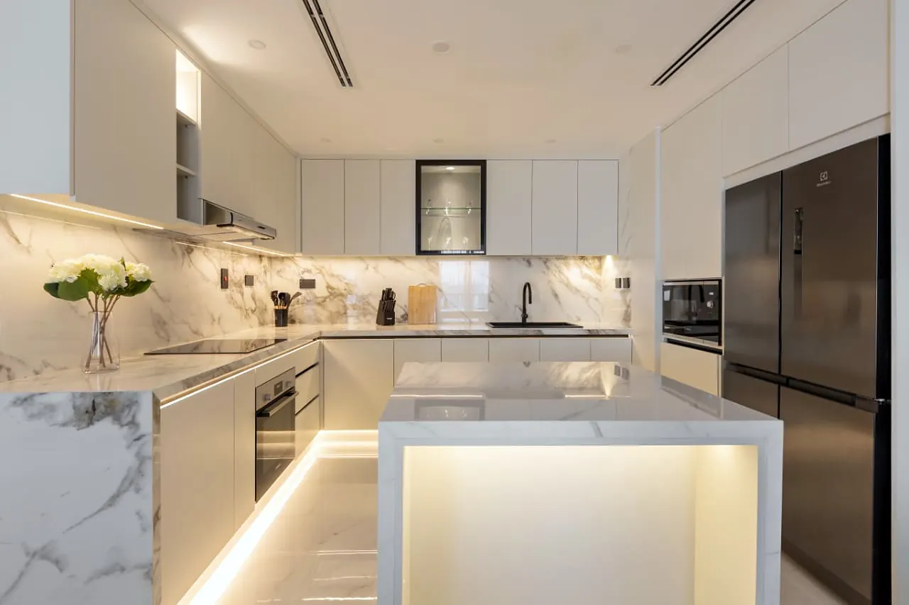 White kitchen island and under-counter lighting