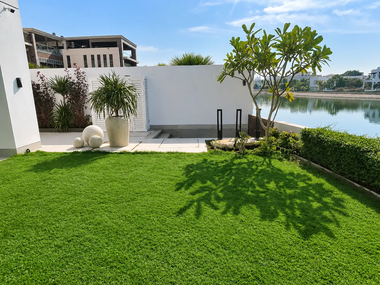 Waterfront villa lawn and planting